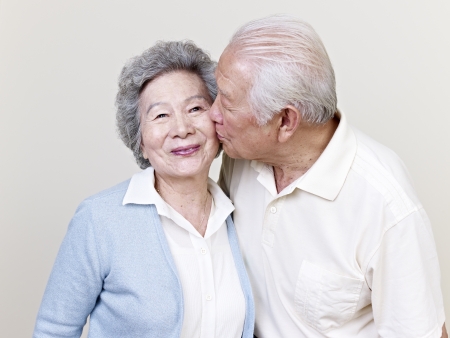 portrait of a senior asian couple kissingの写真素材
