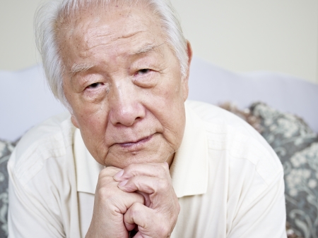 portrait of a sad asian senior man の写真素材