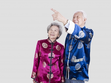 studio portrait of a senior chinese couple の写真素材