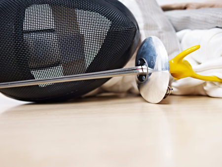 fencing mask and rapier on floor.