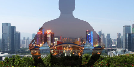 silhouette of a man superimposed on a panorama view of a modern city.