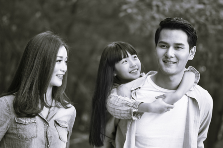 young asian family walking enjoying nature, black and white.の写真素材