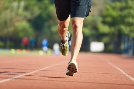 young asian man   exercising on track.