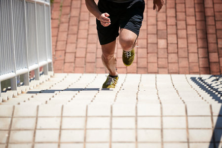 young asian adult male athlete using steps to train speed and strength.