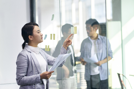 young asian business woman and men working in office.の写真素材