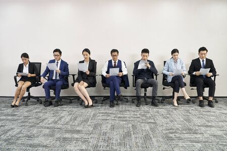 group of asian business people waiting in line for job interviewの写真素材