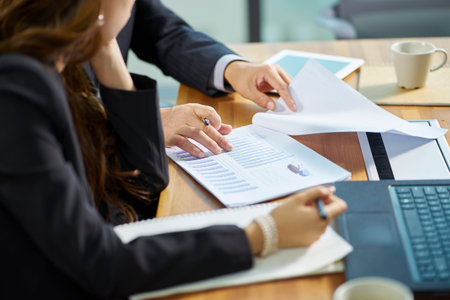 asian corporate executives working together reviewing business in office