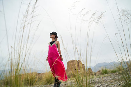 asian woman in red dress walking in a desolate historical site