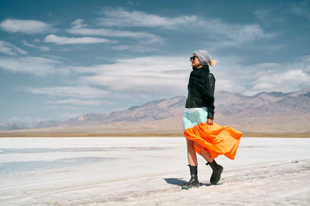 asian woman female tourist in long skirt walking on saline alkali landの写真素材