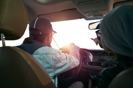 asian couple looking at view while traveling by car
