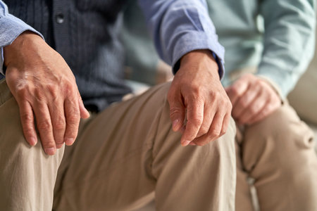 two asian senior people sitting on chairs togetherの写真素材