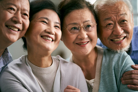 portrait of two happy senior asian couples looking at camera smilingの写真素材