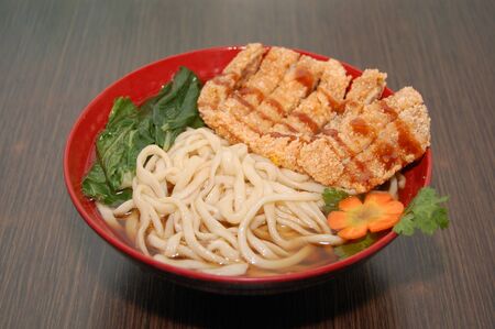 Chinese pork and chicken strips noodle soup bowlの写真素材