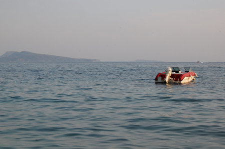 BATANGAS, PH - APRIL 23: Tali beach late in the afternoon with speed boat on April 23, 2011 in...