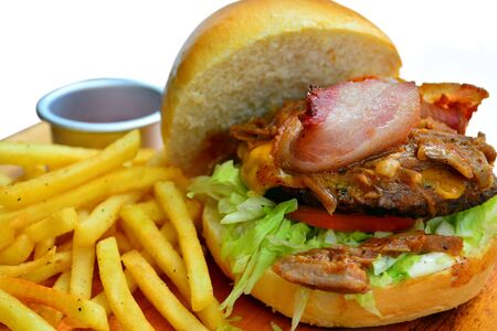 Hamburger with beef patty, bacon, lettuce and French fries mealの写真素材