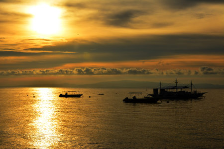 Sunrise scenery at the sea in Dauin, Negros Oriental, Philippines. 
