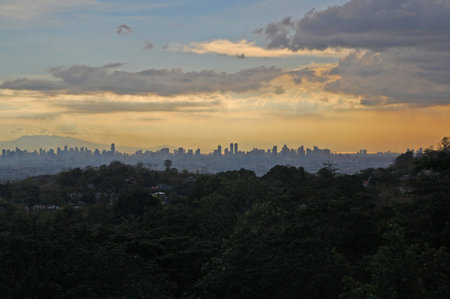 RIZAL, PH - MAY 14: City overview of Metro Manila at sunset on May 14, 2011 in Antipolo, Rizal,...