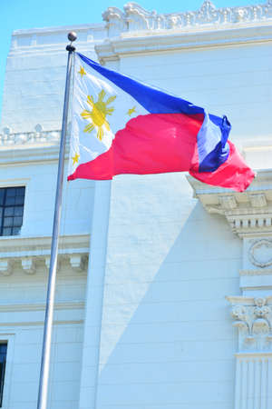 Manila, PH - JULY 6: National flag of the Philippines in Rizal Park on July 6, 2016. The Philippine flag is a horizontal flag bicolor with equal bands of royal blue and scarlet, and a white triangle.のeditorial素材