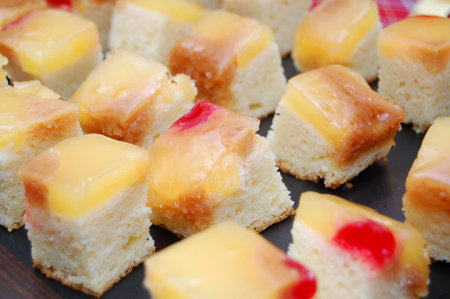Fruit cake with sliced pineapple and cherry on top to be serve as appetizer