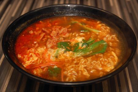 Spicy hot ramen Korean noodles with vegetable, soup, and meatの写真素材