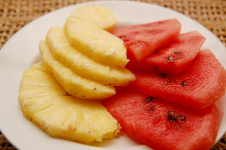Watermelon and pineapple on plate serve in hotel resortの写真素材