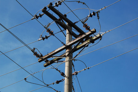 Electric post with hanging wires powering up homes and offices