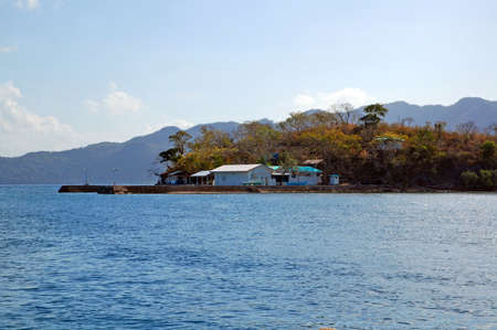 PALAWAN, PH - MARCH 8 - Island with houses and trees on March 8, 2012 in Coron, Palawan, Philippines.のeditorial素材