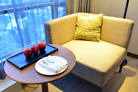 Complimentary ripe apples with knife, fork, cloth napkin, and plate furniture set up