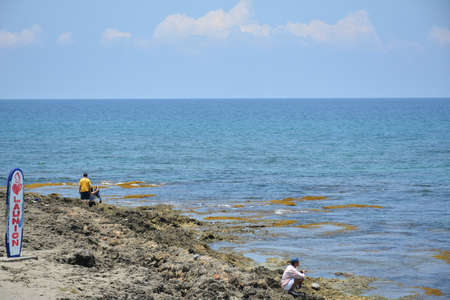 LA UNION, PH - APRIL 18 - Beach water and sands with swimmers on April 18, 2019 in La Union, Philippines.のeditorial素材