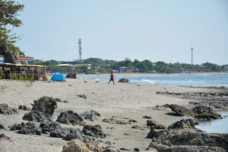 LA UNION, PH - APRIL 18 - Beach water and sands with swimmers on April 18, 2019 in La Union, Philippines.のeditorial素材