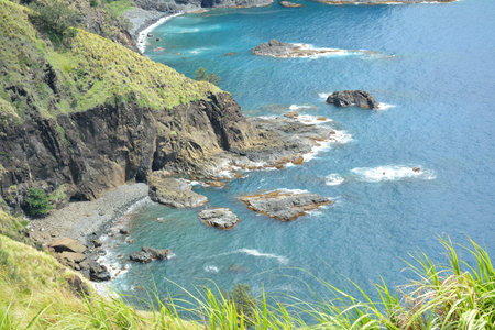 Rock formation and sea water at mountain view white beach resort in Dingalan, Aurora, Philippines