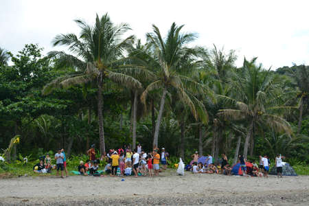 AURORA, PH - APRIL 21 - People gather at White beach resort on April 21, 2019 in Dingalan, Aurora, Philippines.のeditorial素材