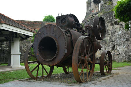 MANILA, PH - OCT. 5 - Baluarte De San Diego rusty locomotive train and parts display at Intramuros walled city on October 5, 2019 in Manila, Philippines.のeditorial素材