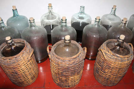Big jar bottle storage in brown weave basket use to store perfume contentの写真素材