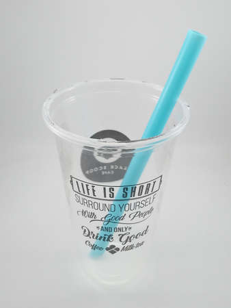 MANILA, PH - SEPT 24 - Black scoop cafe drinking cup with straw on September 24, 2020 in Manila, Philippines.のeditorial素材