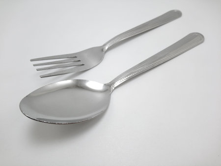 Stainless steel metal eating utensil spoon and fork use for eating food mealの写真素材