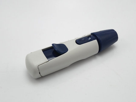 Lancet pen use to pinch fingertip of person for glucose test