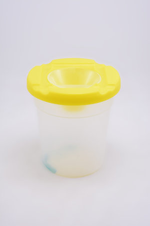 Coloring paint transparent cup use to put water and art brush while not in use