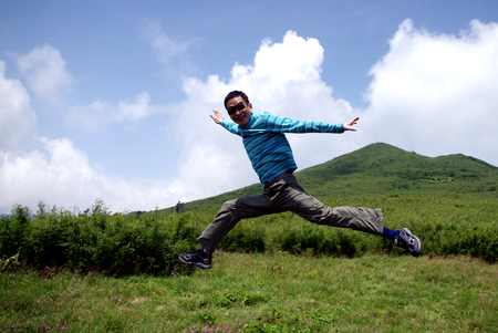 man jumping on green grassの写真素材