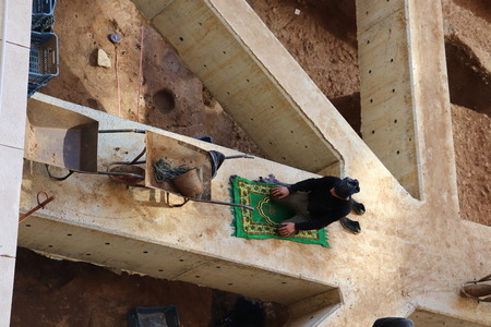 man praying in construction siteの写真素材