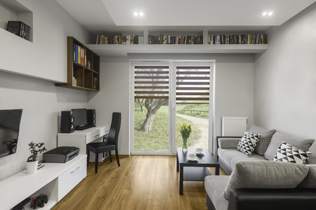 Bookshelf above window in modern living roomの写真素材