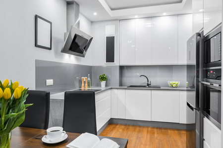 Modern and white kitchen with dining tableの写真素材