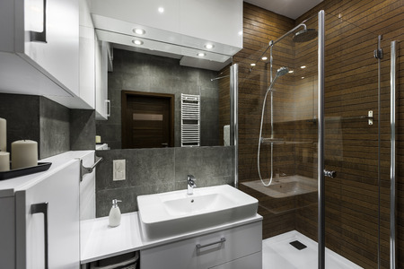 Stylish new bathroom with wooden wall in showerの写真素材