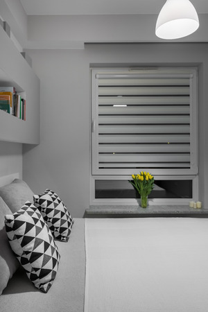 Big window with white blinds in modern bedroomの写真素材