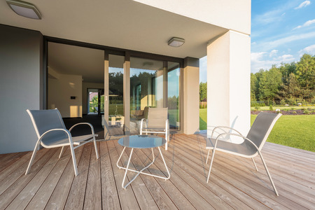 Modern villa with patio, simple outdoor furniture setの写真素材