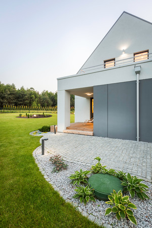 Image of new villa with wide lawn and stone drivewayの写真素材