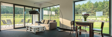 Simple living and dining room combination, spacious interior with window wall system, panoramaの写真素材