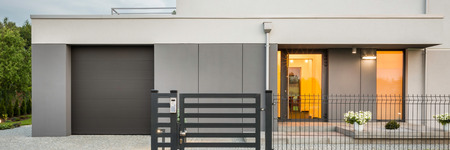 Panoramic photo of new design villa with decorative fence, garage and stone driveway, external viewの写真素材
