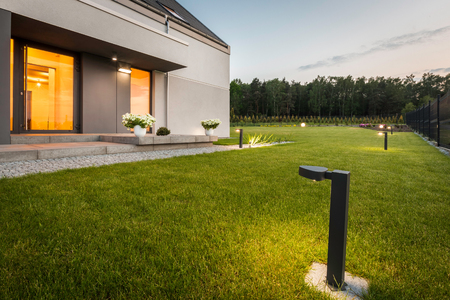 Image of modern villa with garden and decorative outdoor lighting, external viewの写真素材