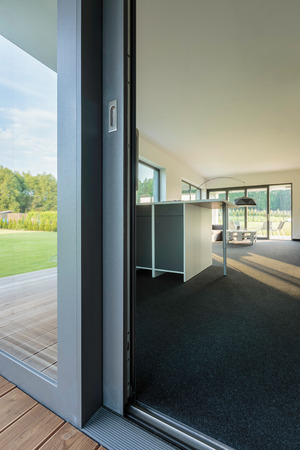 Close up of glass balcony doors, external view of a spacious villa interiorの写真素材